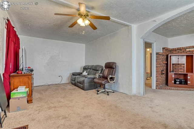 1110 Euclid Ave, Pueblo, CO 81004 - unfurnished room featuring a textured ceiling, carpet flooring, arched walkways, and ceiling fan