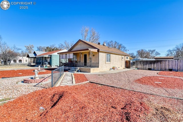 1110 Euclid Ave, Pueblo, CO 81004 - view of front facade with a porch and stucco siding