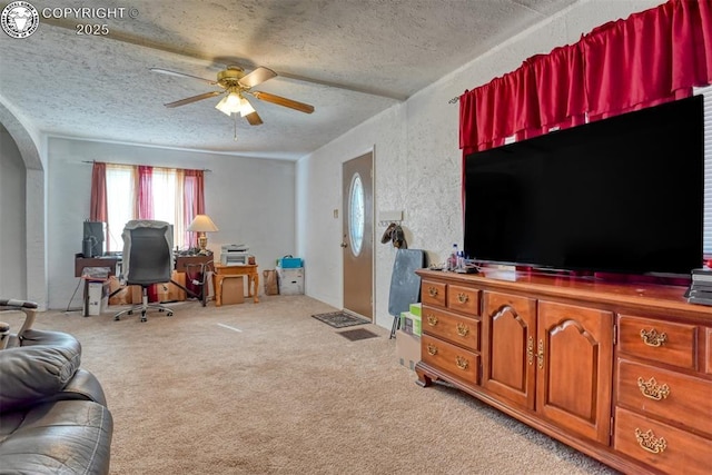 1110 Euclid Ave, Pueblo, CO 81004 - living room with a ceiling fan, arched walkways, light carpet, a textured ceiling, and a desk