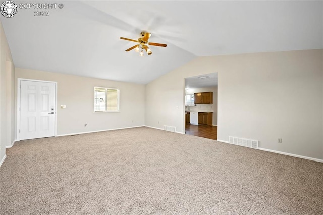 carpeted empty room with ceiling fan and vaulted ceiling