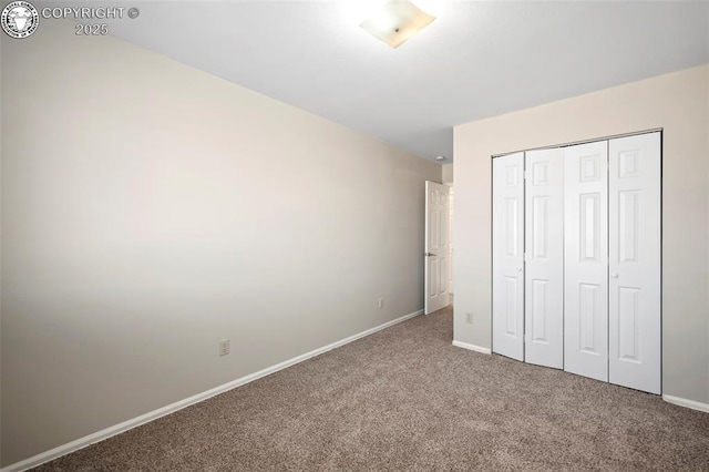 unfurnished bedroom featuring carpet floors and a closet