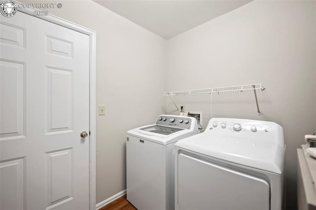 laundry area featuring separate washer and dryer and wood-type flooring