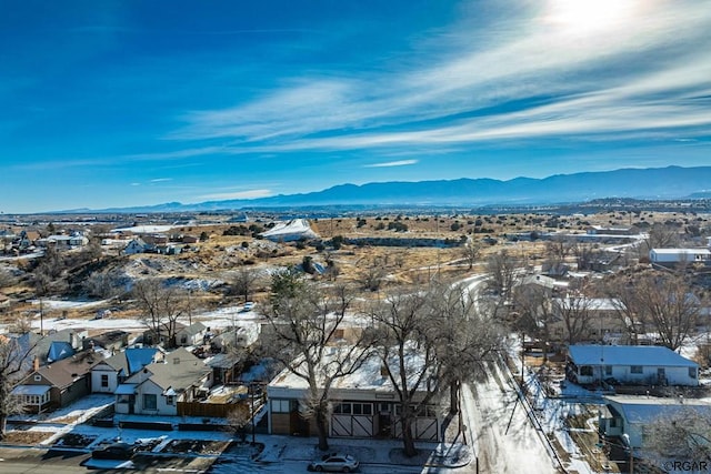 snowy aerial view with a mountain view