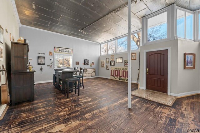 dining room featuring ornamental molding, dark hardwood / wood-style floors, and a healthy amount of sunlight