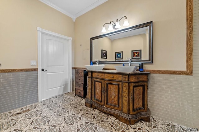 bathroom featuring tile patterned flooring, crown molding, tile walls, and vanity