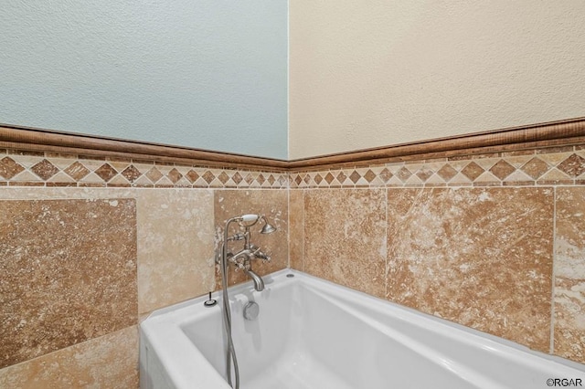 bathroom featuring a tub to relax in and tile walls