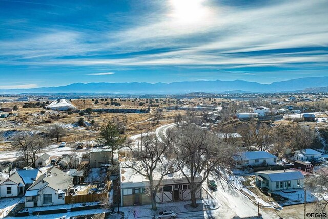 snowy aerial view with a mountain view