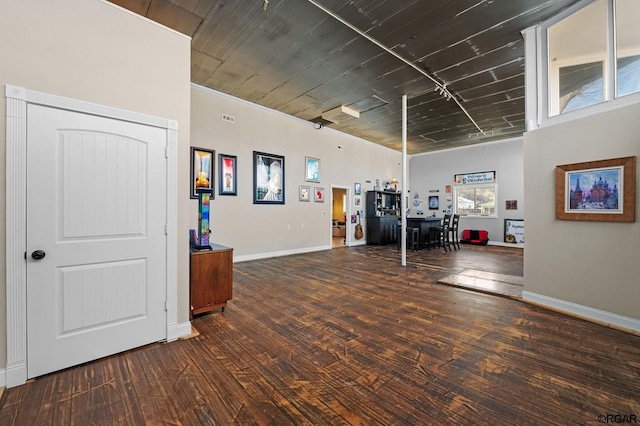 interior space with wood ceiling and dark hardwood / wood-style floors