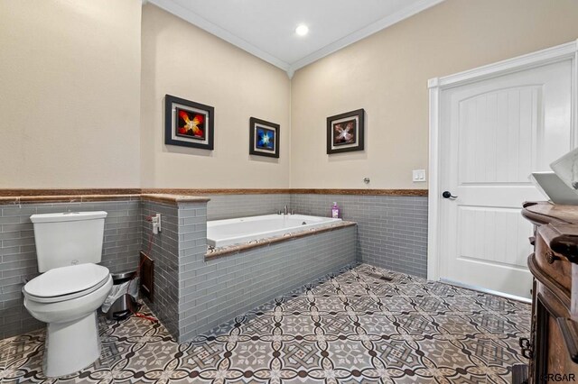 bathroom with crown molding, tile patterned floors, toilet, and tile walls