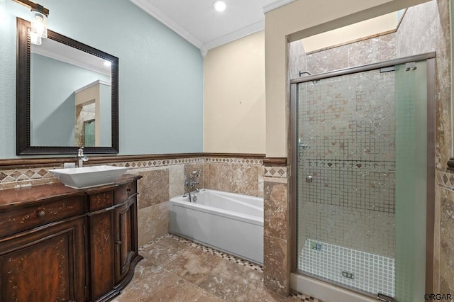 bathroom featuring tile walls, vanity, ornamental molding, and plus walk in shower