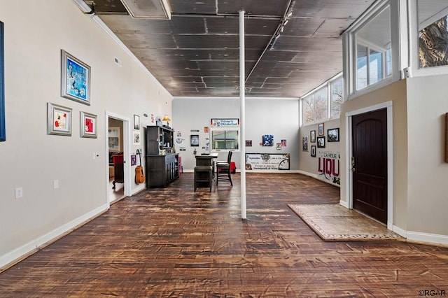 entrance foyer with dark hardwood / wood-style floors and a high ceiling