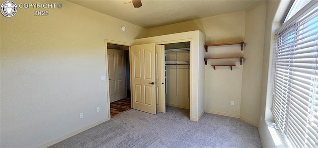 unfurnished bedroom with light carpet, a ceiling fan, baseboards, and a closet