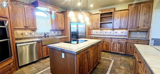 kitchen featuring stainless steel appliances, a sink, wooden counters, a center island, and open shelves