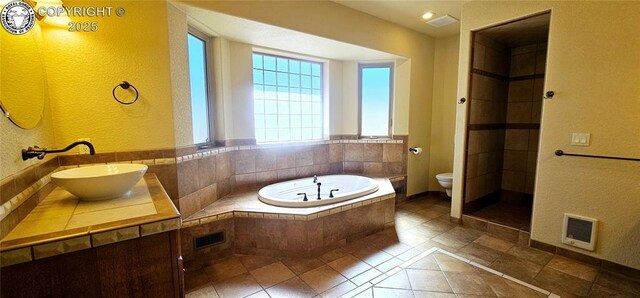 full bath featuring tile patterned flooring, a garden tub, toilet, visible vents, and vanity