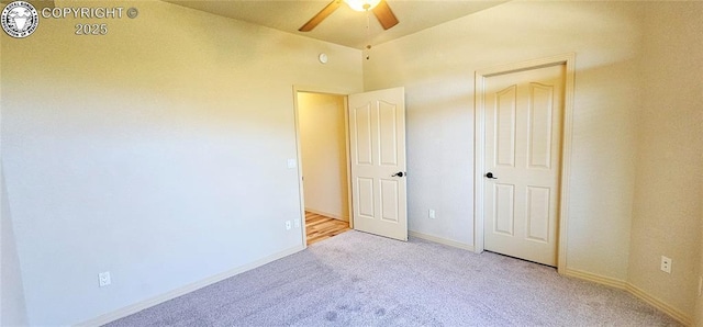 unfurnished bedroom featuring carpet floors, baseboards, and a ceiling fan