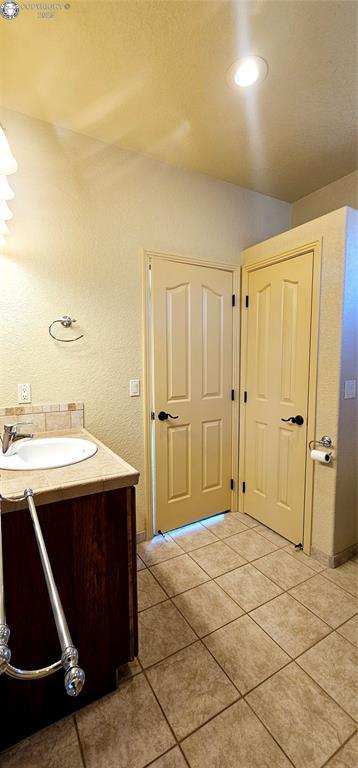 bathroom with vanity and tile patterned floors