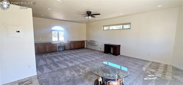 interior space with carpet floors, electric panel, baseboards, and a ceiling fan