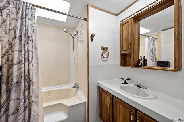 bathroom with vanity, shower / tub combo with curtain, and a skylight