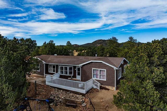 rear view of house featuring a mountain view