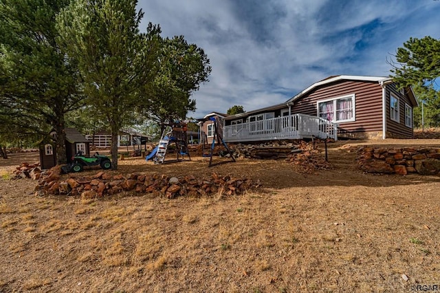 view of yard featuring a playground and a deck