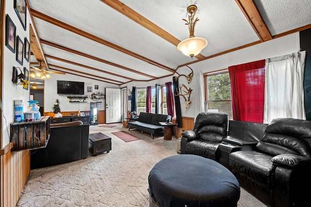 living room featuring a healthy amount of sunlight, light carpet, a textured ceiling, and vaulted ceiling with beams