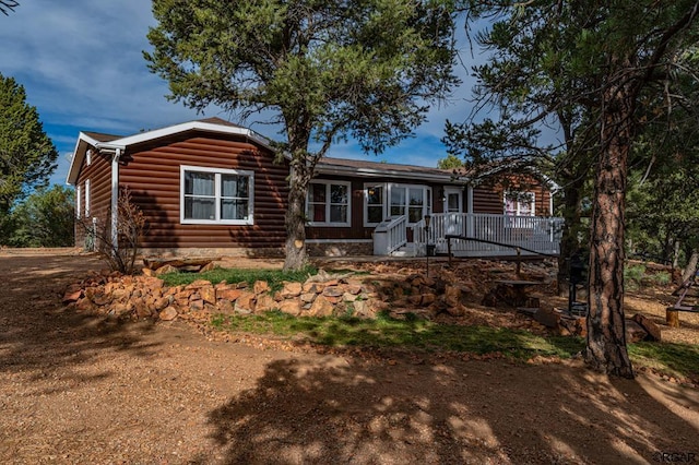 back of property with a wooden deck