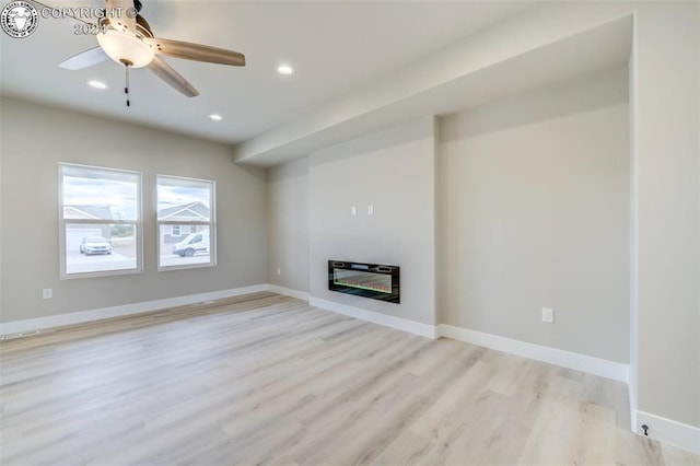 unfurnished living room with ceiling fan, light hardwood / wood-style floors, and heating unit