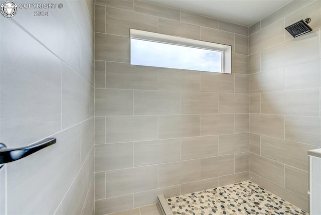 bathroom with a tile shower