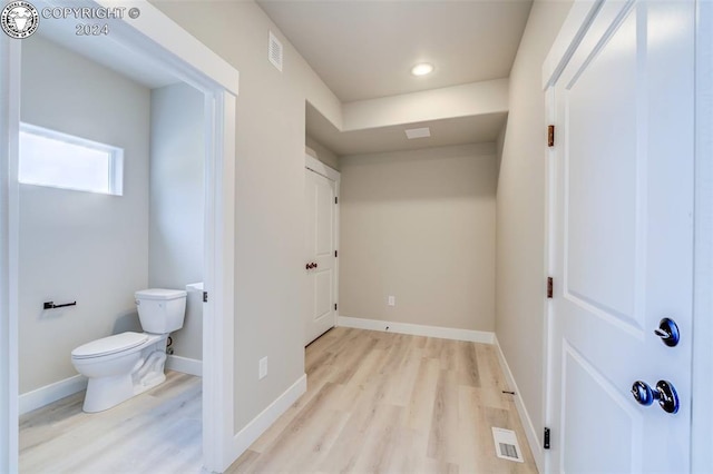 bathroom featuring hardwood / wood-style flooring and toilet