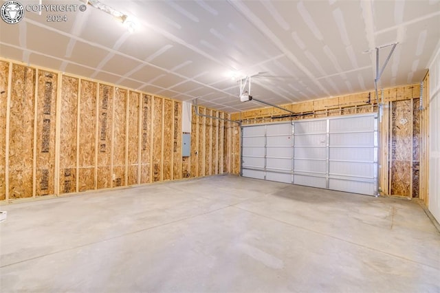 garage with a garage door opener and electric panel