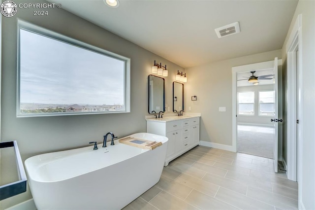 bathroom with vanity and a bath