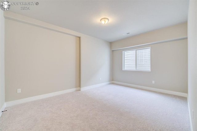 empty room featuring light carpet