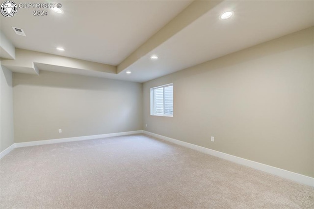 basement featuring light colored carpet