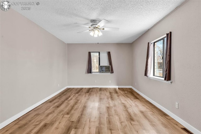 unfurnished room with a textured ceiling, ceiling fan, and light hardwood / wood-style floors