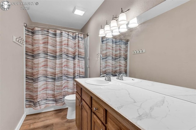 full bathroom with wood-type flooring, toilet, shower / tub combo, and vanity