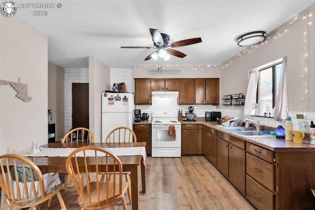 kitchen with sink, white appliances, ceiling fan, backsplash, and light hardwood / wood-style floors