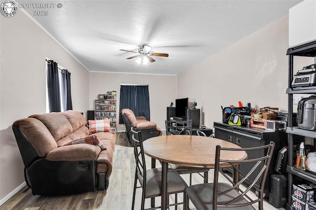 dining space featuring wood-type flooring and ceiling fan