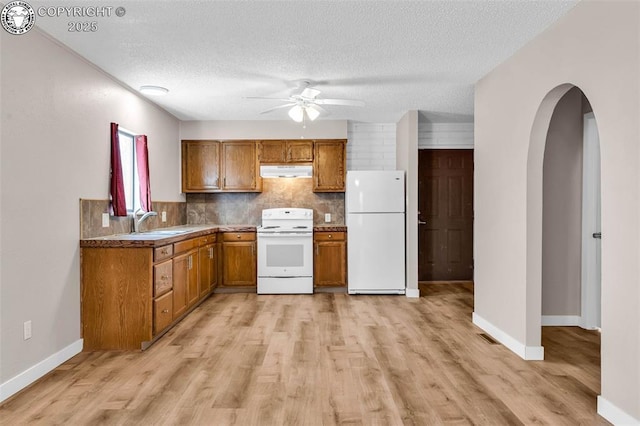 kitchen with sink, decorative backsplash, white appliances, ceiling fan, and a textured ceiling