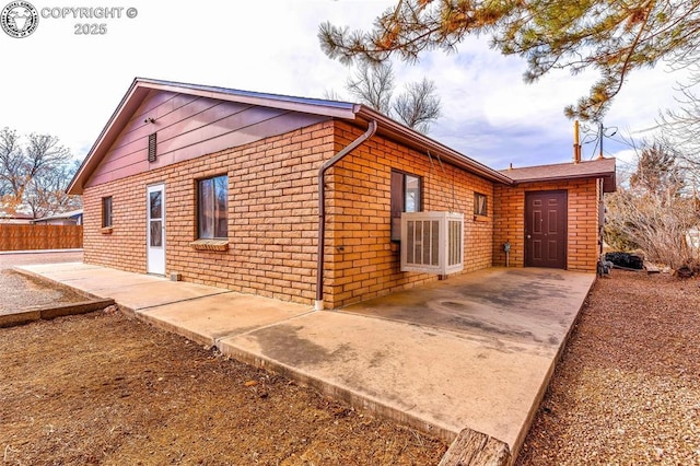 view of property exterior featuring central AC unit and a patio area