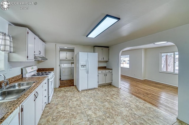 kitchen featuring white cabinetry, white appliances, independent washer and dryer, and sink