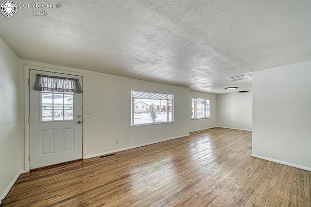 interior space featuring hardwood / wood-style floors and a textured ceiling