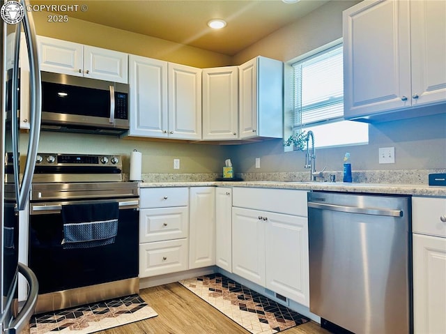 248 Indian Hills Rd, Florence, CO 81226 - kitchen with white cabinets, light countertops, appliances with stainless steel finishes, and recessed lighting