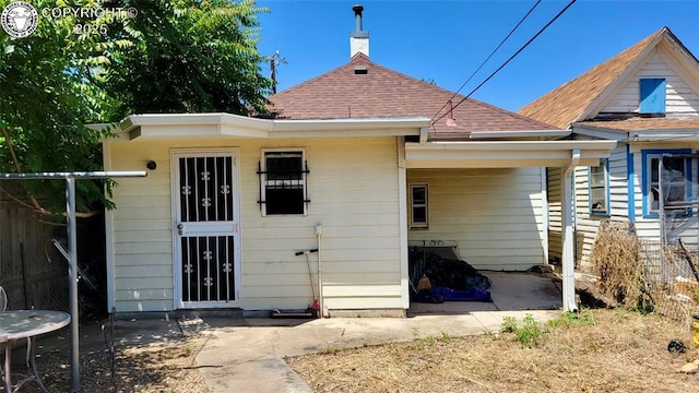 1318 Spruce St, Pueblo, CO 81004 - back of property with a shingled roof and a patio area