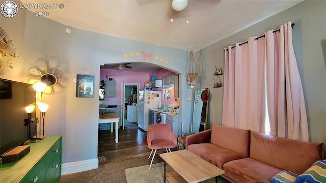 1318 Spruce St, Pueblo, CO 81004 - living room featuring ceiling fan, arched walkways, and carpet flooring