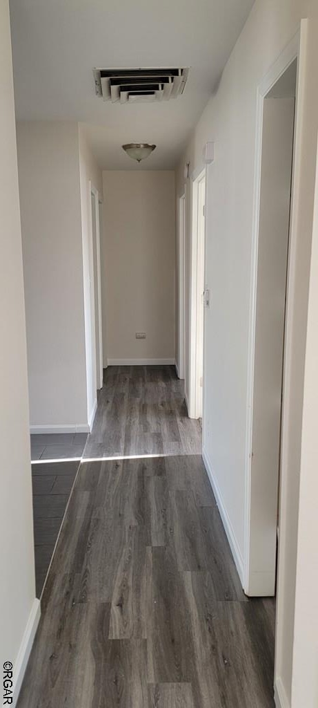 hallway featuring dark wood-type flooring