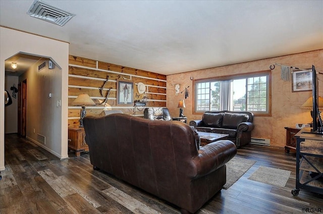 living area with log walls, visible vents, dark wood-style floors, and baseboard heating