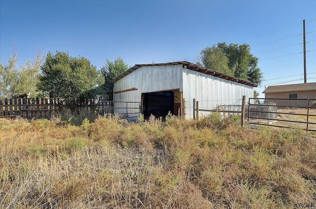view of pole building with fence