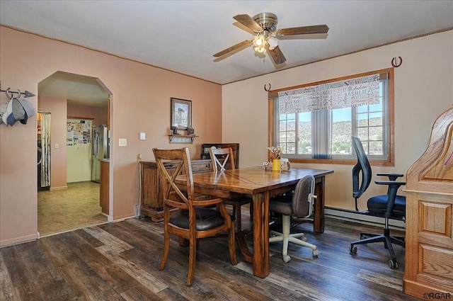 dining area featuring a baseboard radiator, dark hardwood / wood-style floors, and ceiling fan