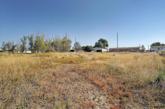 view of yard with a rural view