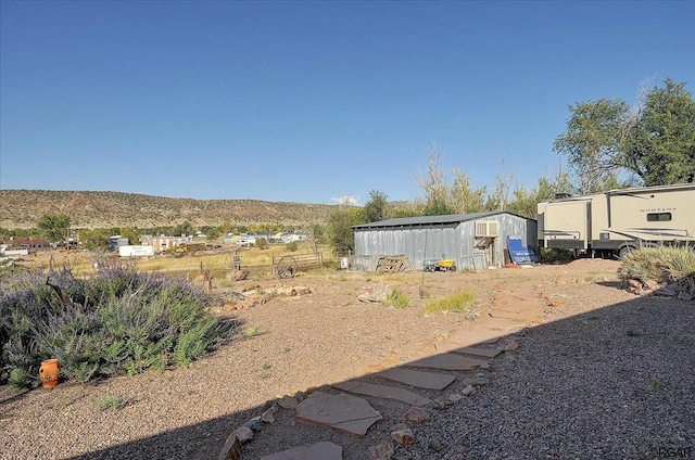 view of yard with an outdoor structure and a mountain view